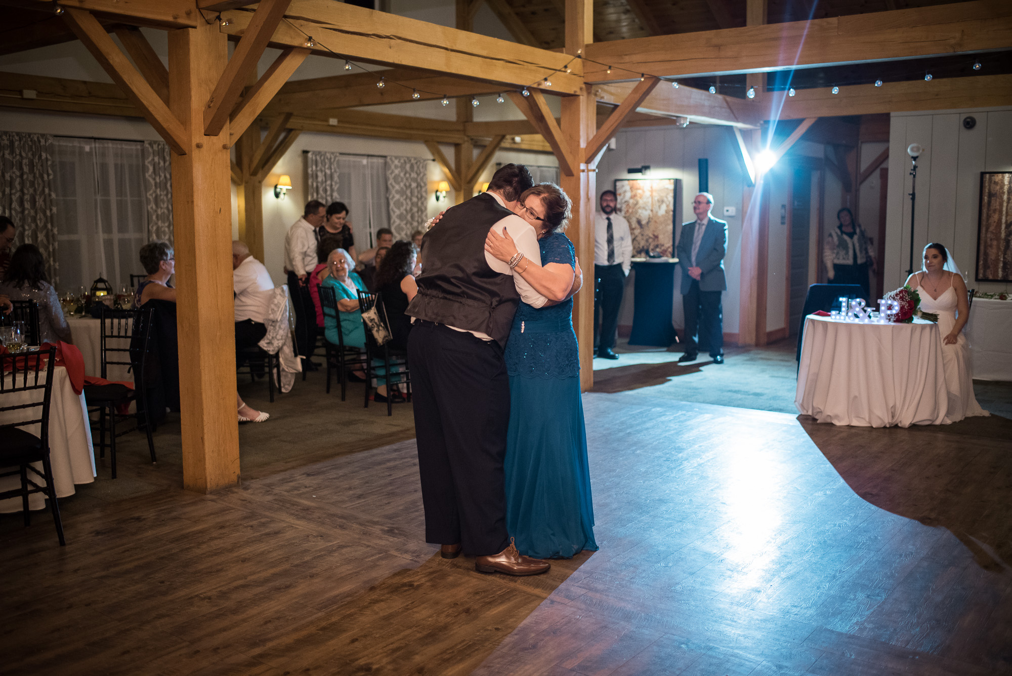 parent dances during a wedding reception at barn wedding venue